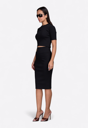 Model wearing monogram slim-fit pencil skirt, front view – East Vibe